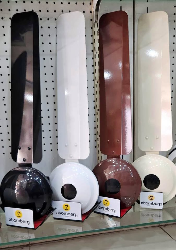 Close-up of Atomberg Ikano 1400 mm BLDC ceiling fan blades and motor housing in black, white, brown, and ivory finishes