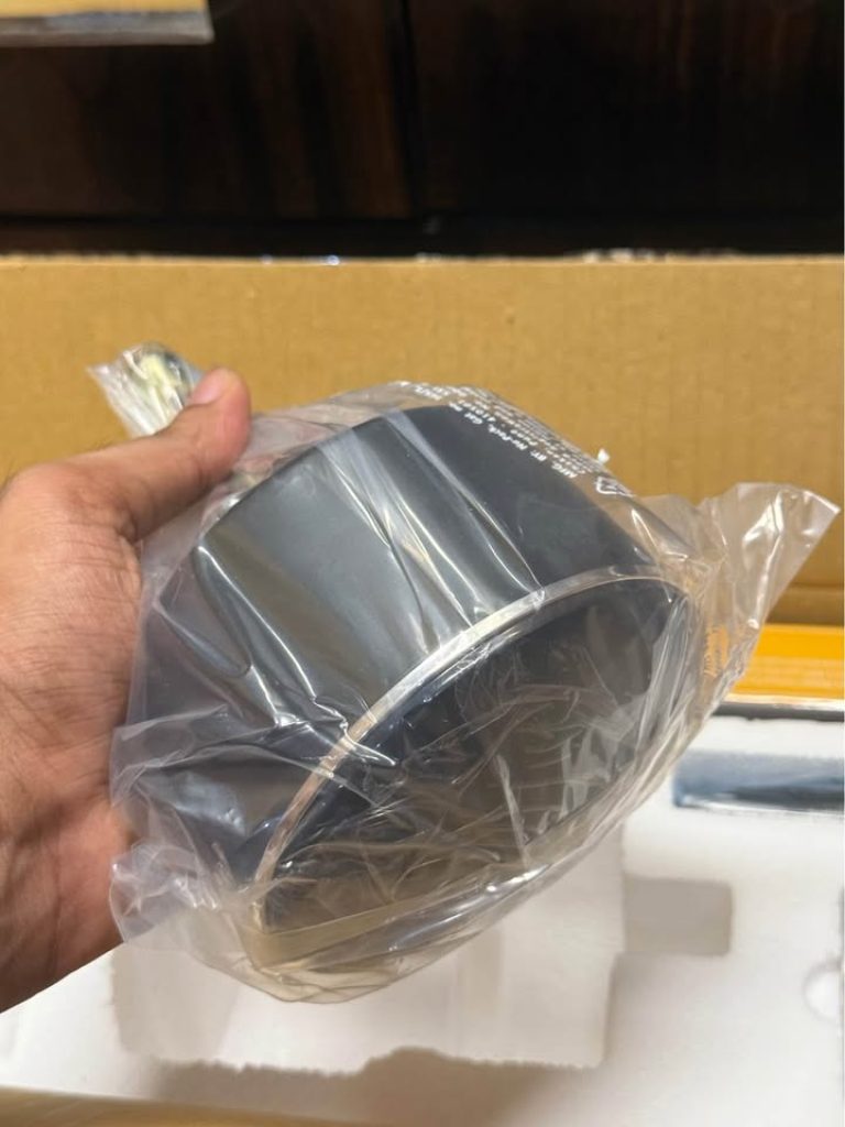 Atomberg Renesa Halo Smart 1400mm BLDC ceiling fan canopy held in hand during unboxing for a closer view