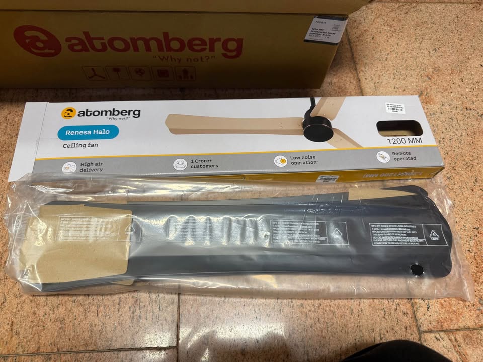 Packaged aluminium blades of the Atomberg Renesa Halo Smart BLDC ceiling fan placed beside the product box during unboxing