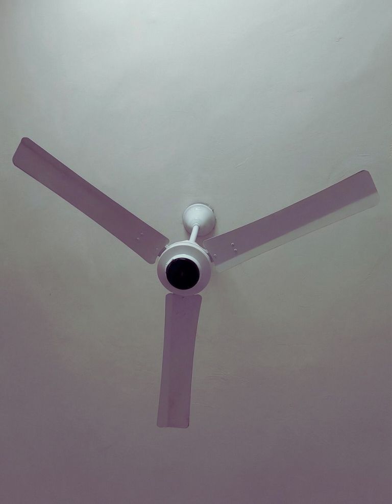 Close view of Orient Electric I Tome Pro 1400 mm BLDC ceiling fan blades and central motor housing mounted on the ceiling